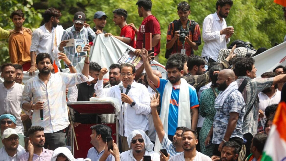 Cockroach Janta Party's (CJP) founder Abhijeet Dipke (in white) and others raise slogans during a protest demanding the resignation of Union Education Minister Dharmendra Pradhan over alleged examination-related lapses, at the Jantar Mantar, in New Delhi, Saturday. (PTI Photo)